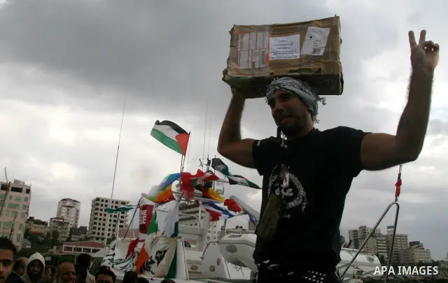 This October 29, 2008 file photo shows Italian peace activist Vittorio Arrigoni at the port in Gaza City celebrating the arrival of the 20-metre (65-foot) ship "Dignity" that departed from Cyprus the previous day to prot...