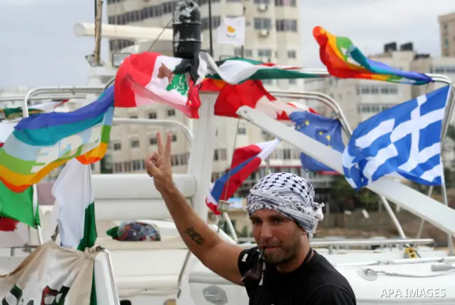 This October 29, 2008 file photo shows Italian peace activist Vittorio Arrigoni at the port in Gaza City celebrating the arrival of the 20-metre (65-foot) ship "Dignity" that departed from Cyprus the previous day to prot...