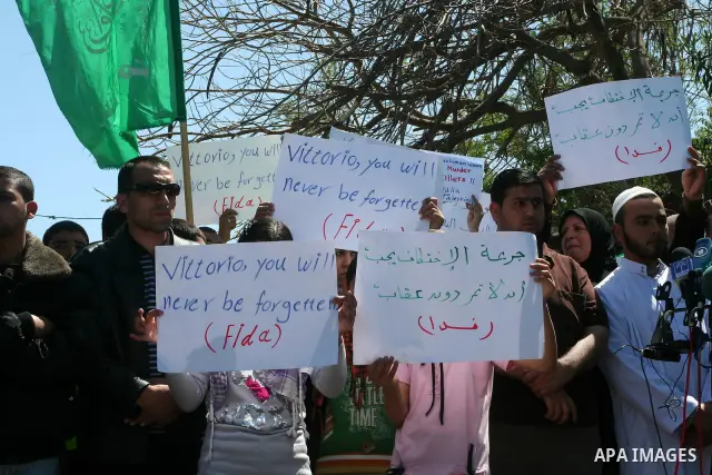 Palestinians hold slogans against the kidnapping and killing of an Italian human rights activist by a Salafist group of radical Islamist, during a protest in Gaza City, on April 15, 2011. International Solidarity Movemen...