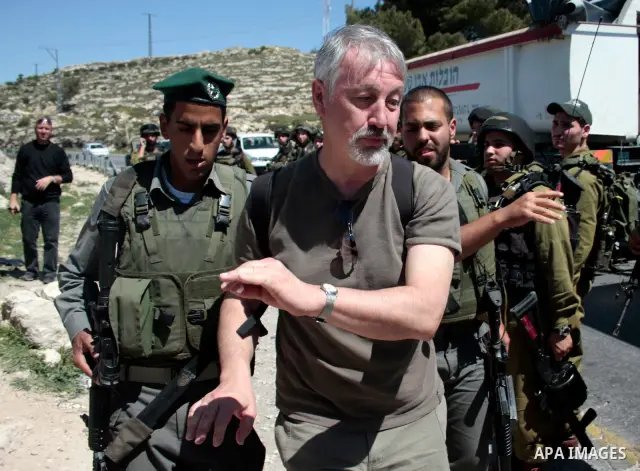 Israeli soldiers arrest a protester during a demonstration against Israel's controversial separation barrier and in support with Vittorio Arrigoni after kidnapping him in Gaza, in the West Bank village of Maasarah, near...