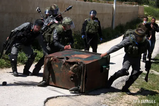 Israeli soldiers take position during a protest by Palestinian and foreign demonstrators against the expropriation of land to expand the Jewish settlement of Halmish, in the Palestinian village of Nabi Saleh, in the Isra...