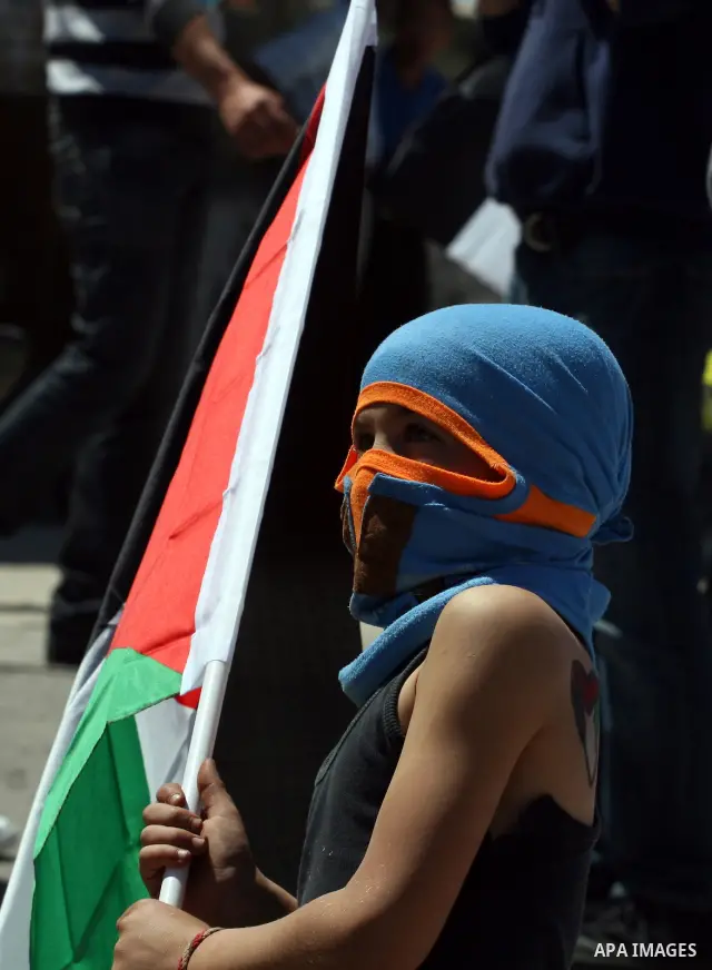 A Palestinian demonstrator takes part in a protest against the expropriation of land to expand the Jewish settlement of Halmish, in the Palestinian village of Nabi Saleh, in the Israeli-occupied West Bank, on April 15, 2...