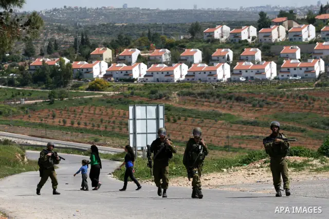 Israeli soldiers take position during a protest by Palestinian and foreign demonstrators against the expropriation of land to expand the Jewish settlement of Halmish, in the Palestinian village of Nabi Saleh, in the Isra...