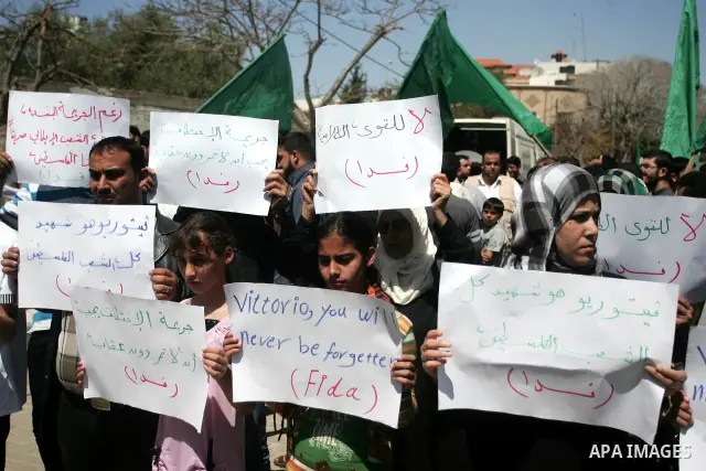 Palestinians hold slogans against the kidnapping and killing of an Italian human rights activist by a Salafist group of radical Islamist, during a protest in Gaza City, on April 15, 2011. International Solidarity Movemen...