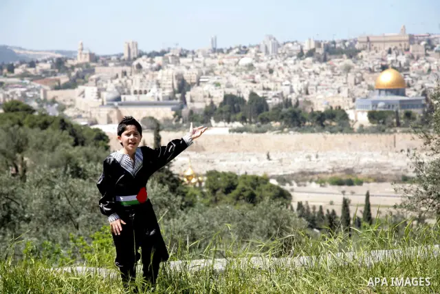 The Palestinian child Issam Bashiti, who was participated in the program Arab's got talent, delivers poetry in front of media in Jerusalem's old city on April 15,2011. The Dome of the Rock shown in the background. Photo...