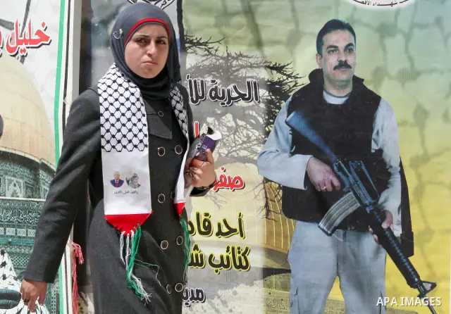Palestinians students take part during a rally demanding the release of their loved ones from Israeli jails in Al Quds Open University in the West Bank city of Hebron, on April 16, 2011.Photo by Najeh Hashlamoun