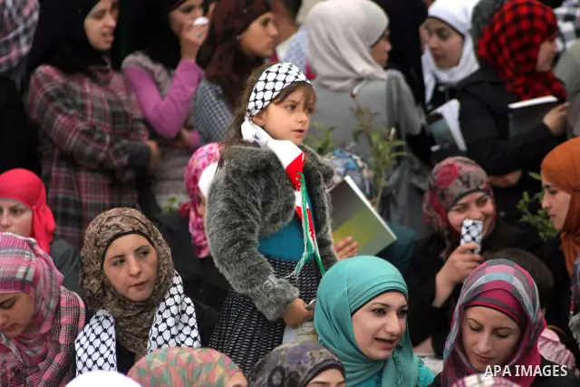 Palestinians students take part during a rally demanding the release of their loved ones from Israeli jails in Al Quds Open University in the West Bank city of Hebron, on April 16, 2011.Photo by Najeh Hashlamoun