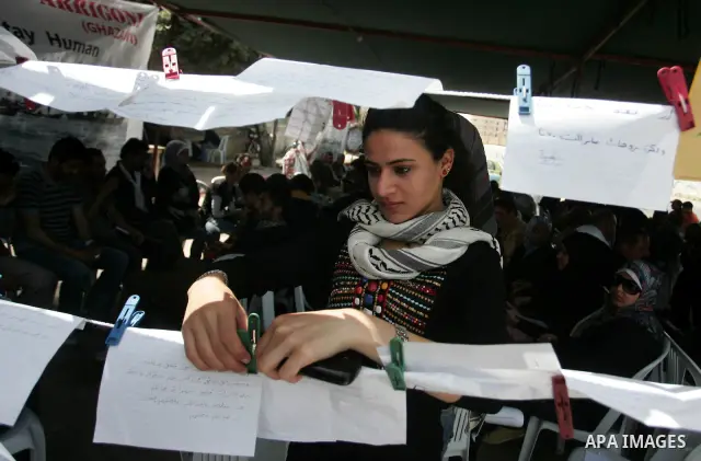 Palestinians sit in a mourning tent for the Italian peace activist Vittorio Arrigoni at Gaza seaport, April 16, 2011. Arrigoni, 36, was found killed early Friday at an abandoned house in northern Gaza Strip after hours o...
