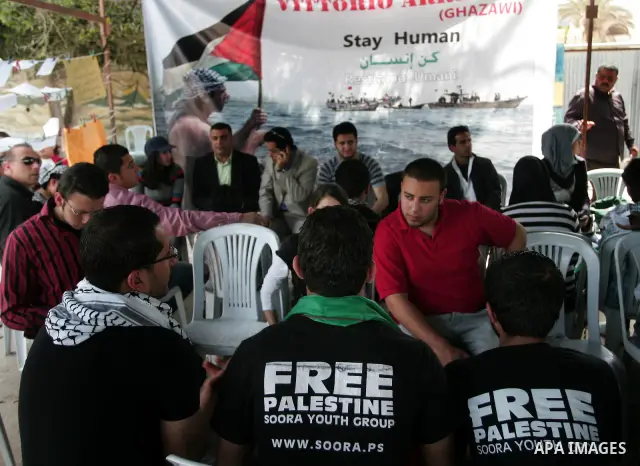 Palestinians sit in a mourning tent for the Italian peace activist Vittorio Arrigoni at Gaza seaport, April 16, 2011. Arrigoni, 36, was found killed early Friday at an abandoned house in northern Gaza Strip after hours o...