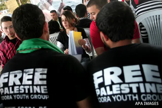 Palestinians sit in a mourning tent for the Italian peace activist Vittorio Arrigoni at Gaza seaport, April 16, 2011. Arrigoni, 36, was found killed early Friday at an abandoned house in northern Gaza Strip after hours o...