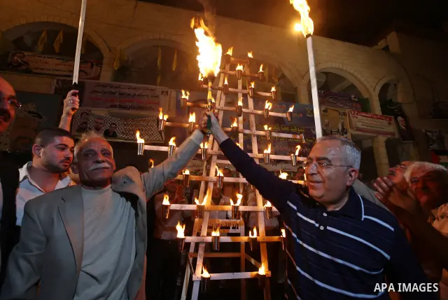 Palestinian Pime Minister, Salam Fayyad lights the flame of freedom to mark the Prisoners Day in the West Bank city of Qalqilya on April 16, 2011. Photo by Mustafa Abu Dayeh