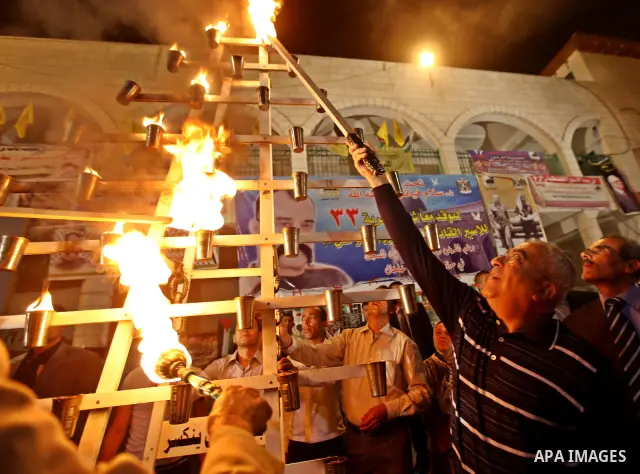 Palestinian Pime Minister, Salam Fayyad lights the flame of freedom to mark the Prisoners Day in the West Bank city of Qalqilya on April 16, 2011. Photo by Mustafa Abu Dayeh