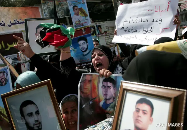 Palestinians hold pictures of their jailed relatives during a rally, one of several taking place across the Israeli occupied West Bank and Gaza Strip, calling for the release of Palestinians being held in Israeli jails,...