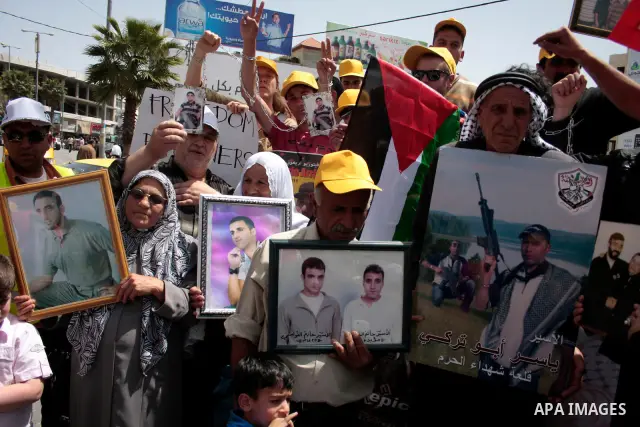 Palestinians take part in a rally, one of several taking place across the Israeli occupied West Bank and Gaza Strip calling for the release of Palestinians being held in Israeli jails, as they mark Palestinian Prisoner's...