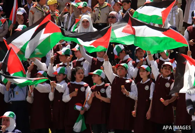 Palestinian schoolgirls hold up flags during a protest to mark Prisoner's Day in the West Bank city of Nablus, Sunday, April 17, 2011. Some 5,500 Palestinians are held in Israeli prisons according to figures compiled in...
