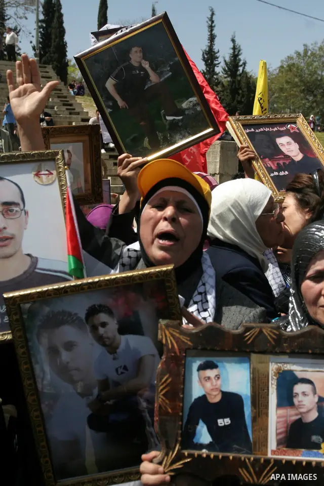 Palestinian women hold photographs of relatives jailed in Israel, during a protest to mark Prisoner's Day in the West Bank city of Nablus, Sunday, April 17, 2011. Some 5,500 Palestinians are held in Israeli prisons accor...