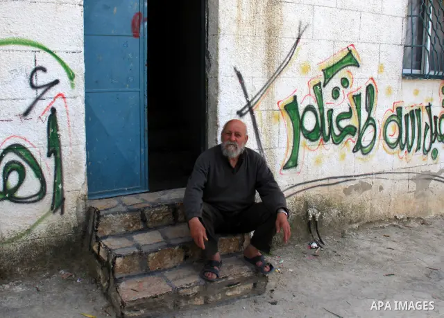 Palestinian Hasan Awad a grandfather of Hakim Awad is seen next to his house in the West Bank village of Awarta near Nablus City on 17 April 2011. Israel has arrested Awad and his cousin in connection with the deadly sta...