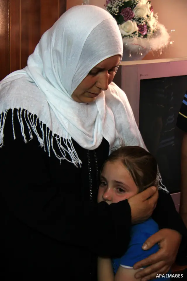 Palestinian Shama Awad, mother of Amjad Awad, suspected in a stabbing attack that killed Jewish settler family, talks to journalists at her home in the West Bank village of Awarta near Nablus, Sunday, April 17, 2011. Isr...