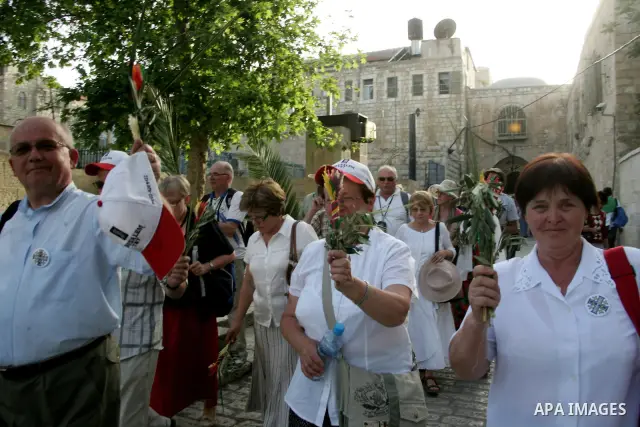 Christian pilgrims take part the Palm Sunday procession from Mt. Olives into Jerusalem's old city on April 17, 2011, marking the triumphant return of Jesus Christ to Jerusalem when a cheering crowd greeted him waving pal...