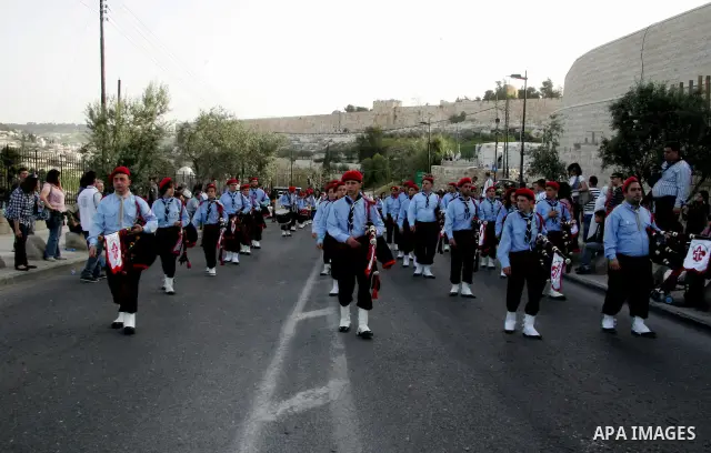 Christian scouts take part in the Palm Sunday procession from Mt. Olives into Jerusalem's old city on April 17, 2011, marking the triumphant return of Jesus Christ to Jerusalem when a cheering crowd greeted him waving pa...