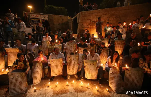 Palestinians light candles during a protest to mark Prisoner's Day in front Damascus Gate in Jerusalem's old city, Sunday, April 17, 2011. Some 5,500 Palestinians are held in Israeli prisons according to figures compiled...