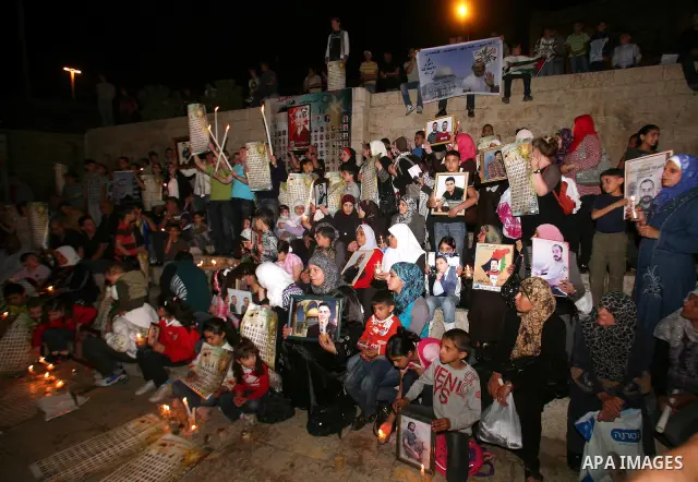 Palestinians light candles during a protest to mark Prisoner's Day in front Damascus Gate in Jerusalem's old city, Sunday, April 17, 2011. Some 5,500 Palestinians are held in Israeli prisons according to figures compiled...