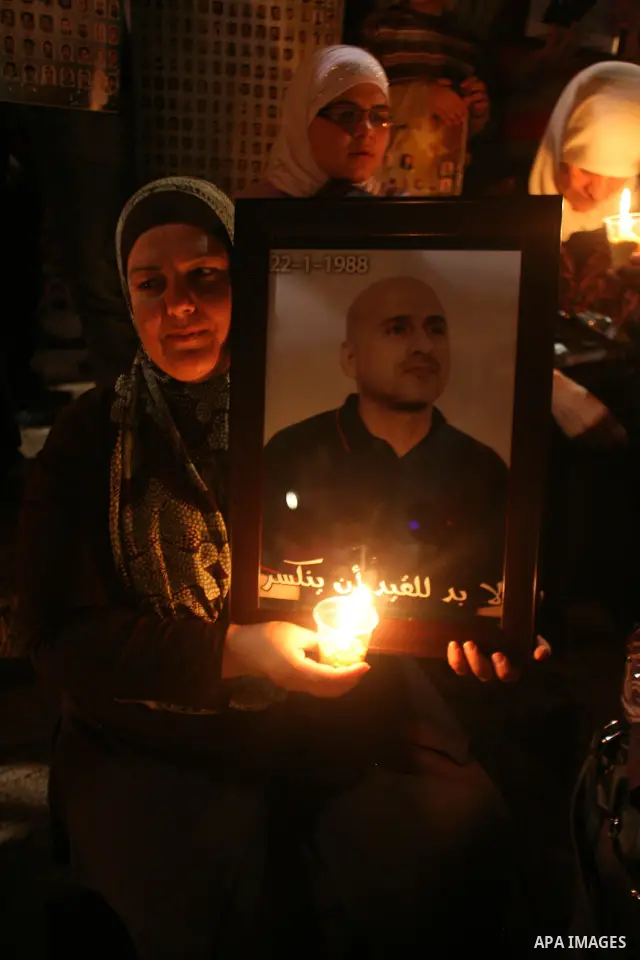 Palestinians light candles during a protest to mark Prisoner's Day in front Damascus Gate in Jerusalem's old city, Sunday, April 17, 2011. Some 5,500 Palestinians are held in Israeli prisons according to figures compiled...