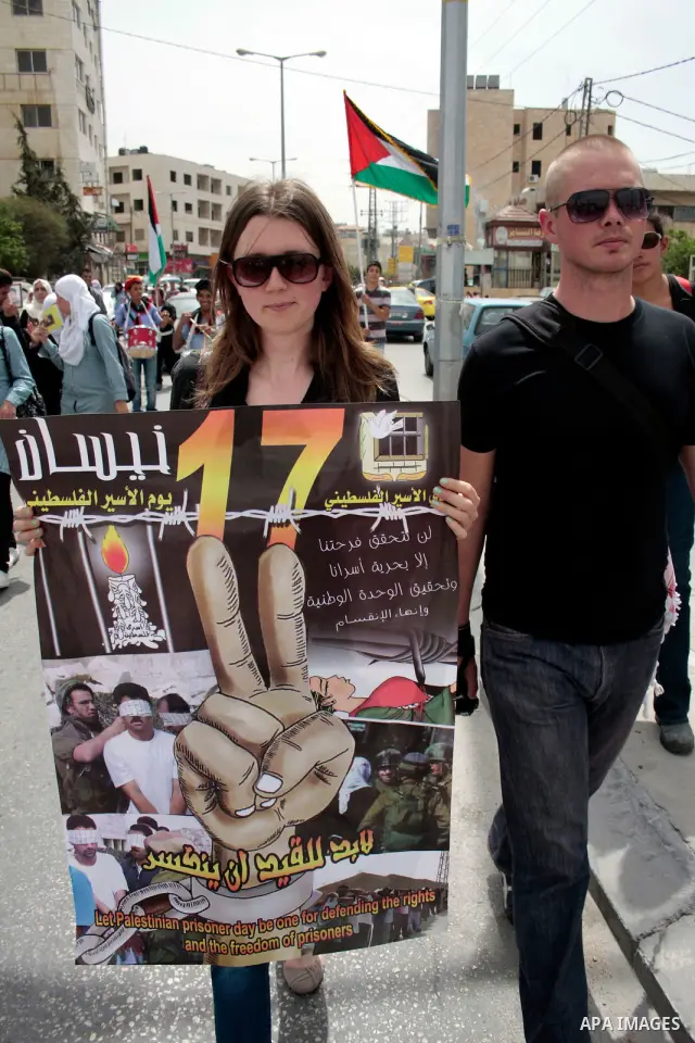 Palestinians hold up a photo of jailed family members as they take part in a rally, one of several taking place across the Israeli occupied West Bank and Gaza Strip, calling for the release of Palestinians being held in...