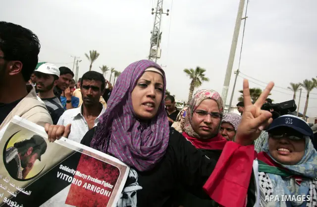 Palestinians chant slogans while carrying the coffin of Italian activist Vittorio Arrigoni, age 36, as they transfer it through Rafah border crossing in southern Gaza Strip, Monday, April 18, 2011. Gaza's Hamas governmen...