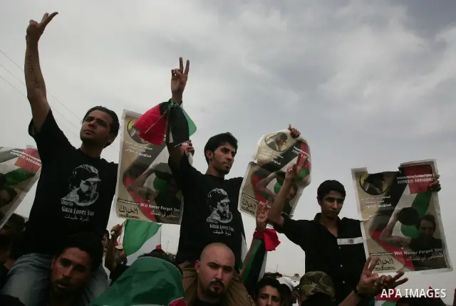 Palestinians chant slogans while carrying the coffin of Italian activist Vittorio Arrigoni, age 36, as they transfer it through Rafah border crossing in southern Gaza Strip, Monday, April 18, 2011. Gaza's Hamas governmen...