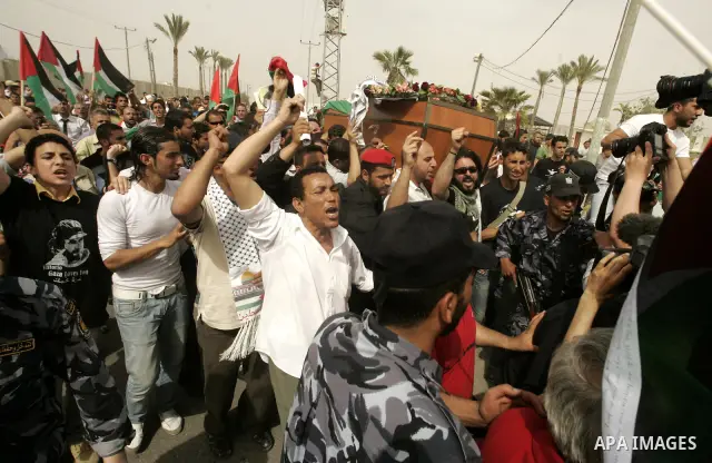 Palestinians and foreigners mourn during the "state funeral" of Italian activist Vittorio Arrigoni in Rafah, southern Gaza Strip, on April 18, 2011 before the transferring of his body to Egypt via the Rafah border crossi...