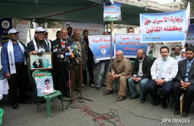 Palestinians hold pictures of their jailed relatives during a rally calling for the release of Palestinians being held in Israeli jails in Gaza City on 19 April 2011. Some 5,500 Palestinians are held in Israeli prisons a...