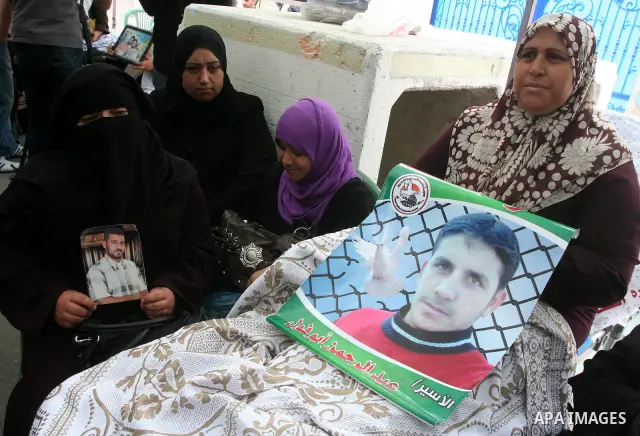 Palestinians hold pictures of their jailed relatives during a rally calling for the release of Palestinians being held in Israeli jails in Gaza City on 19 April 2011. Some 5,500 Palestinians are held in Israeli prisons a...