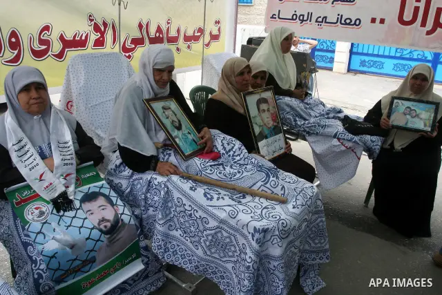 Palestinians hold pictures of their jailed relatives during a rally calling for the release of Palestinians being held in Israeli jails in Gaza City on 19 April 2011. Some 5,500 Palestinians are held in Israeli prisons a...