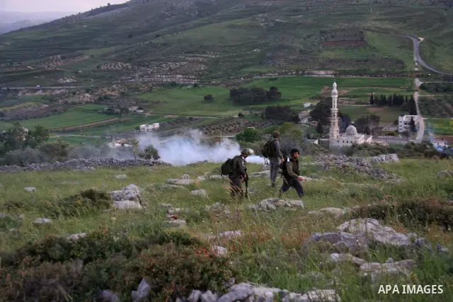 Israeli soldiers arrive at the scene during stone throwing clashes between Jewish settlers from the Har Bracha settlement and local Palestinian villagers close to Burin in the Israeli occupied West Bank on April 19, 2011...