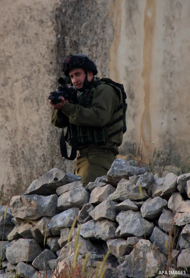 Israeli soldiers arrive at the scene during stone throwing clashes between Jewish settlers from the Har Bracha settlement and local Palestinian villagers close to Burin in the Israeli occupied West Bank on April 19, 2011...