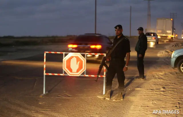 Members of Hamas' security forces search a car near the scene where the main suspects in the killing of a pro-Palestinian Italian activist were killed at the Nuseirat refugee camp in the central Gaza Strip April 19, 2011...