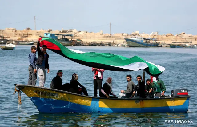Palestinian and foreign activists protest against the kidnapping and killing of Italian human rights activist Vittorio Arrigoni by a Salafist group of radical Islamist at the port in Gaza City, on April 20, 2011, a day a...