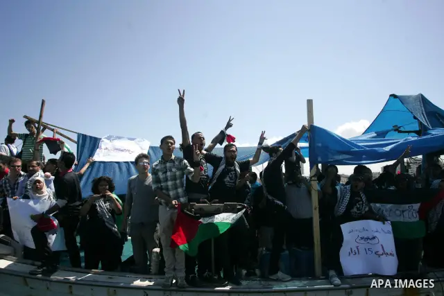 Palestinian and foreign activists protest against the kidnapping and killing of Italian human rights activist Vittorio Arrigoni by a Salafist group of radical Islamist at the port in Gaza City, on April 20, 2011, a day a...