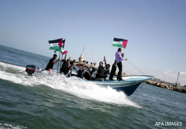 Palestinian and foreign activists protest against the kidnapping and killing of Italian human rights activist Vittorio Arrigoni by a Salafist group of radical Islamist at the port in Gaza City, on April 20, 2011, a day a...