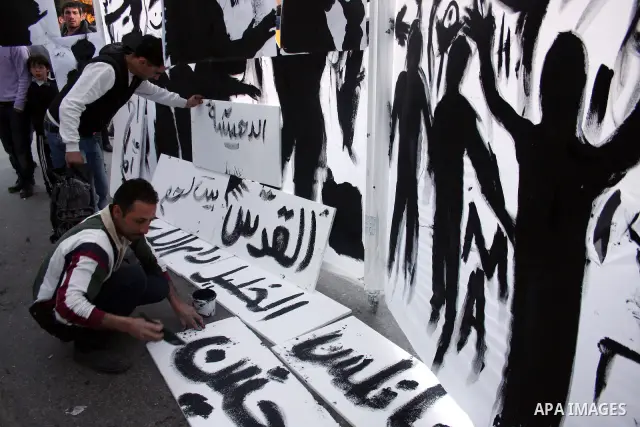 Palestinians participate in exhibition organized by students from Birzeit University in the West Bank city of Ramallah on April 20,2011, in cooperation with Belgium's Lacambre University. The exhibition was erected in th...