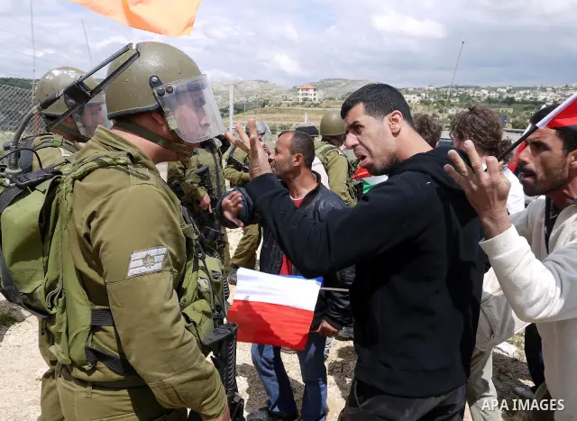 Israeli soldiers scuffle with Palestinian and foreign protesters during the weekly demonstration against Israel's controversial separation barrier in the village of Bilin, near the West Bank city of Ramallah on April 22,...