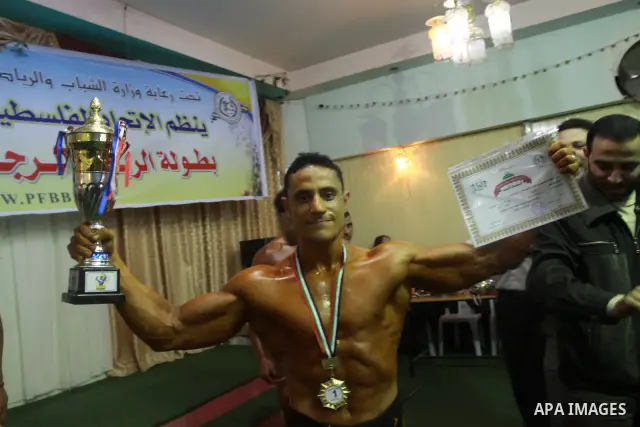 Palestinian men take part during competing in a bodybuilding contest at a hall in Gaza city, Friday, April 22, 2011. Many of the men use women's cosmetics, mud, or paint to enhance their muscles. Number of men from aroun...