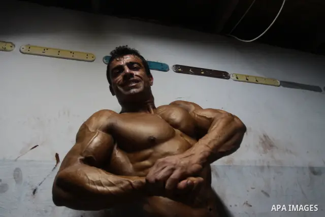 Palestinian men take part during competing in a bodybuilding contest at a hall in Gaza city, Friday, April 22, 2011. Many of the men use women's cosmetics, mud, or paint to enhance their muscles. Number of men from aroun...