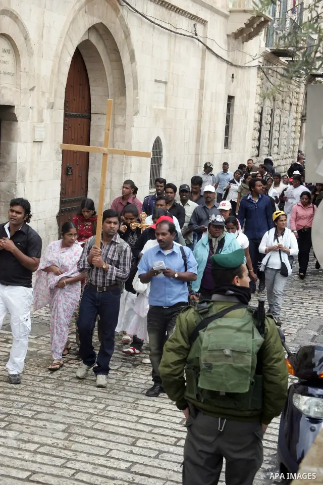 Eastern Orthodox Christians line up as they hold their crosses prior to the start of the Good Friday procession to the Church of the Holy Sepulchre, traditionally regarded as the site of Jesus' crucifixion, burial and re...