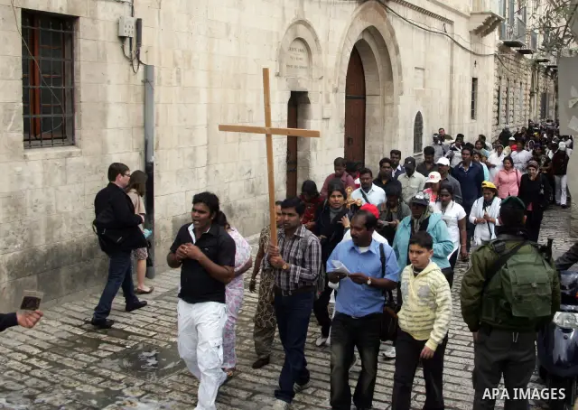 Eastern Orthodox Christians line up as they hold their crosses prior to the start of the Good Friday procession to the Church of the Holy Sepulchre, traditionally regarded as the site of Jesus' crucifixion, burial and re...