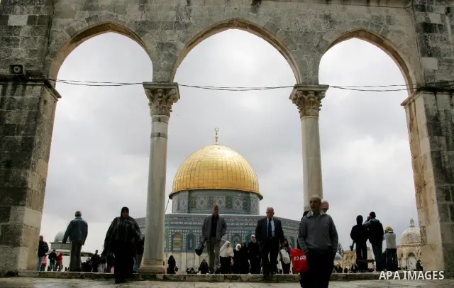 Palestinians walk in front of the Dome of the Rock on the compound known to Muslims as al-Haram al-Sharif, and to Jews as Temple Mount in Jerusalem's Old City April 23, 2011. photo by MAhfouz Abu Turk