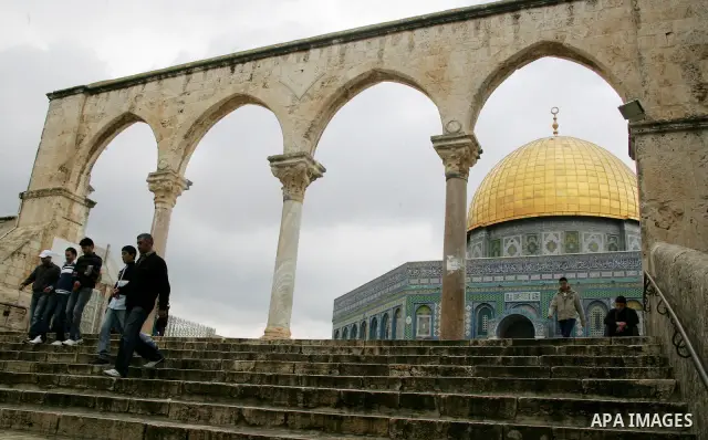 Palestinians walk in front of the Dome of the Rock on the compound known to Muslims as al-Haram al-Sharif, and to Jews as Temple Mount in Jerusalem's Old City April 23, 2011. photo by MAhfouz Abu Turk