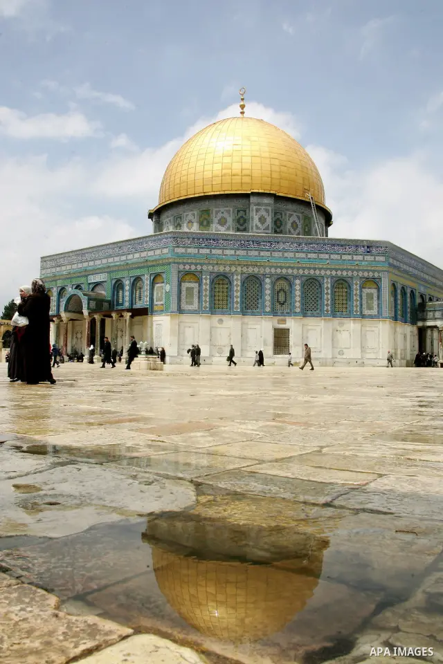 Palestinians walk in front of the Dome of the Rock on the compound known to Muslims as al-Haram al-Sharif, and to Jews as Temple Mount in Jerusalem's Old City April 23, 2011. photo by MAhfouz Abu Turk