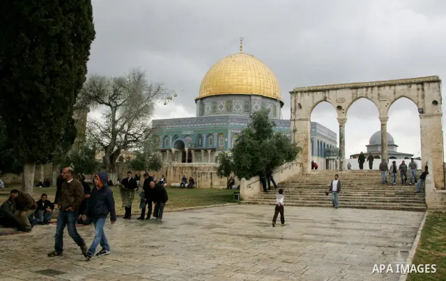 Palestinians walk in front of the Dome of the Rock on the compound known to Muslims as al-Haram al-Sharif, and to Jews as Temple Mount in Jerusalem's Old City April 23, 2011. photo by MAhfouz Abu Turk